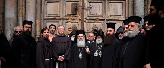 The Custodian of the Holy Land Father Francesco Patton and Greek Orthodox Patriarch of Jerusalem, Theophilos III stand with other church leaders during a news conference in front of the closed doors of the Church of the Holy Sepulchre in Jerusalem
