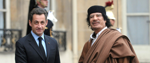 French President Nicolas Sarkozy, left, greets Libyan leader