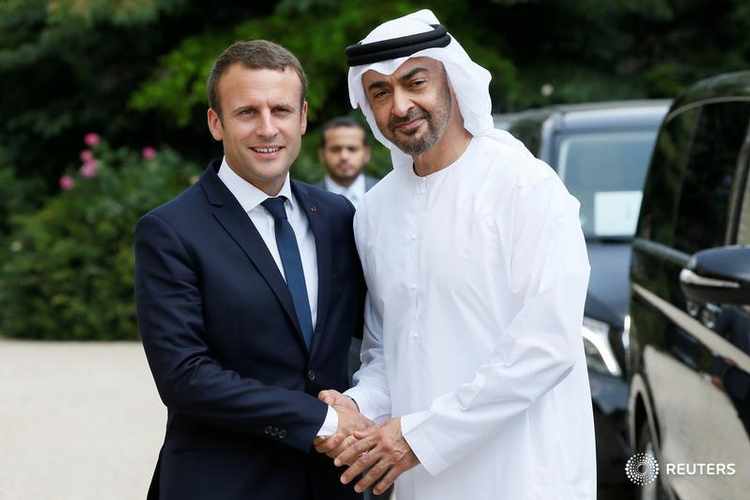 French President Emmanuel Macron accompanies Abu Dhabi's Crown Prince Sheikh Mohammed bin Zayed al-Nahyan after a meeting about Qatar crisis at the Elysee Place in Paris