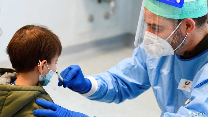 Children receive a flu vaccine in a military hospital